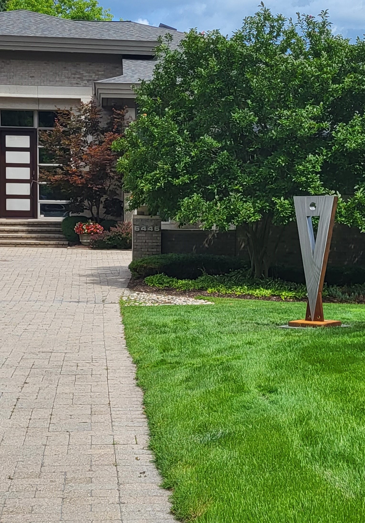 Original sculpture displayed at a landscaped residence